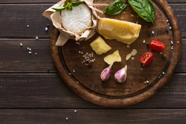 istock Cheese delikatessen closeup on rustic wood, brie and parmesan 818387316