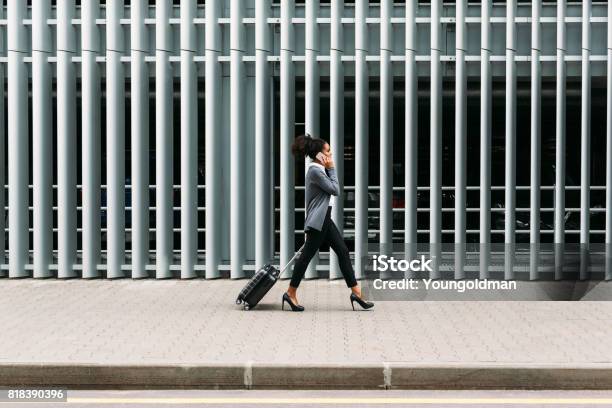 Side View Of Young Businesswoman Walking With Suitcase Stock Photo - Download Image Now