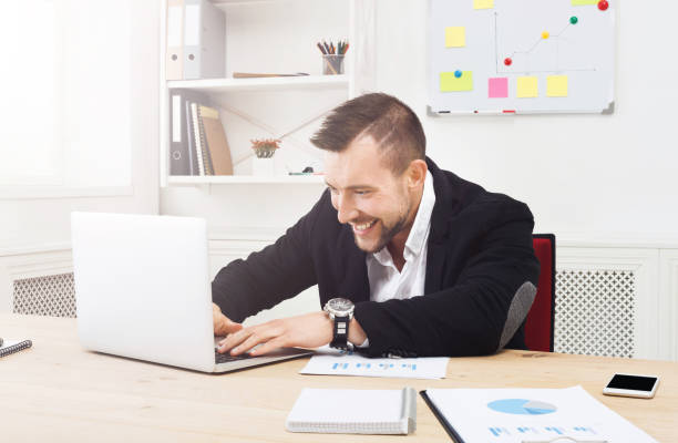 istock Young businessman with laptop in the office 818392266