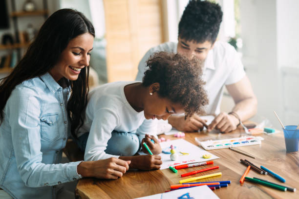 istock Mother and father drawing together with their child 818398744