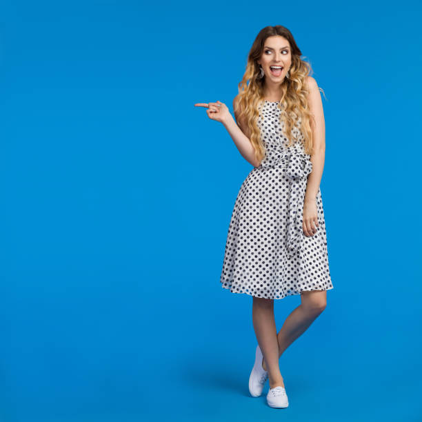 istock Young Woman Is Talking, Pointing And Looking Away 818425374