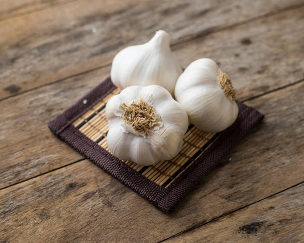 istock Organic garlic on a wooden table in the background .Rustic style. Top view. Free space for text. 818429144