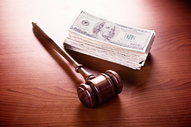 istock Judge's gavel with large cash stash 818447668