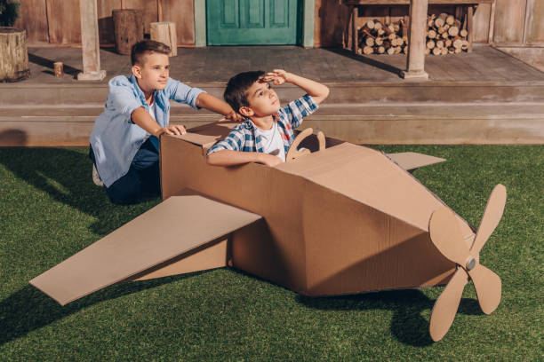istock little boys playing together with handmade cardboard airplane 818448320