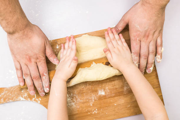 istock Children and dad hands rolled dough 818455582