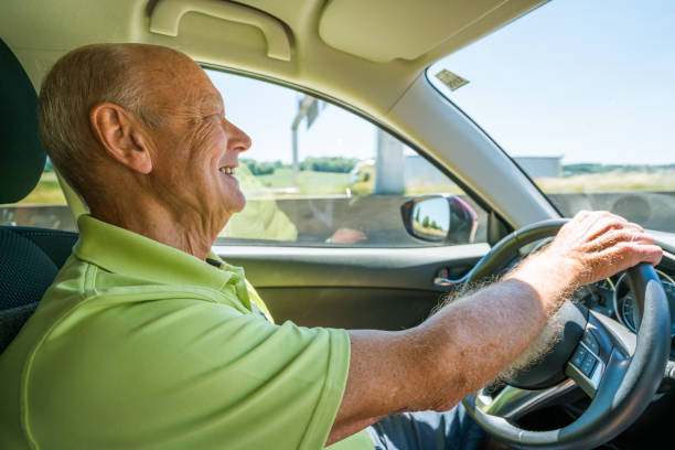 istock Car Trip, smiling senior man driving 818456290