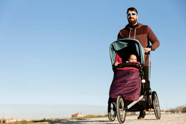 istock Father and son running in the park. 818457070