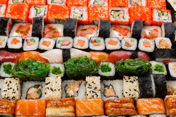 istock Set of sushi, maki and rolls background 818483104