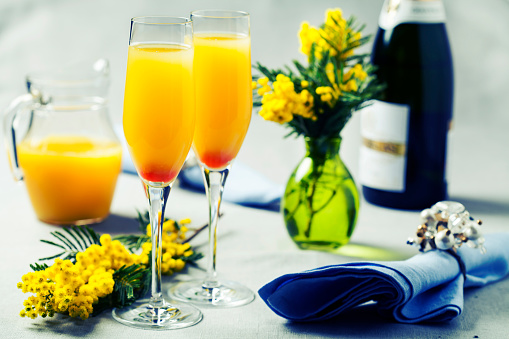 Two glasses with mimosa cocktail (sparkling wine plus orange juice)Two glasses with mimosa cocktail (sparkling wine plus orange juice)