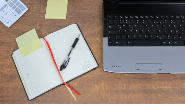 istock Office desk with laptop and personal organizer 818500836