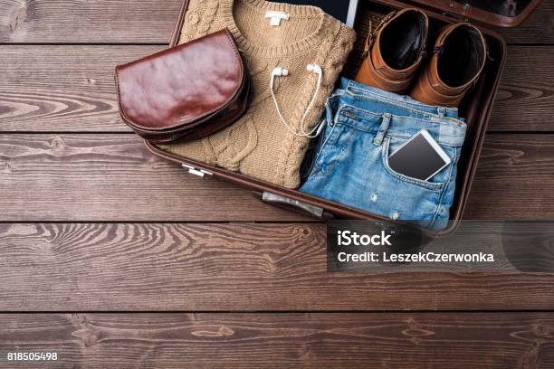 Travel Preparations Concept With Open Suitcase And Womans Casual Clothes Stock Photo - Download Image Now