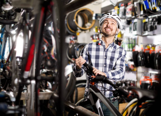 istock Man in helmet chooses convenient bike 818507412