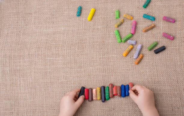 istock Used  color crayons and a toddlers hand 818528098