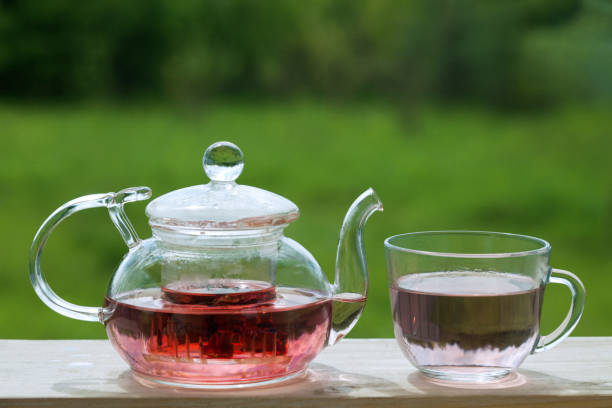 istock Teapot with fragrant herbal tea on a background of nature. 818544760