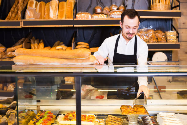 istock Man shows the delicious pastries and cakes 818553900