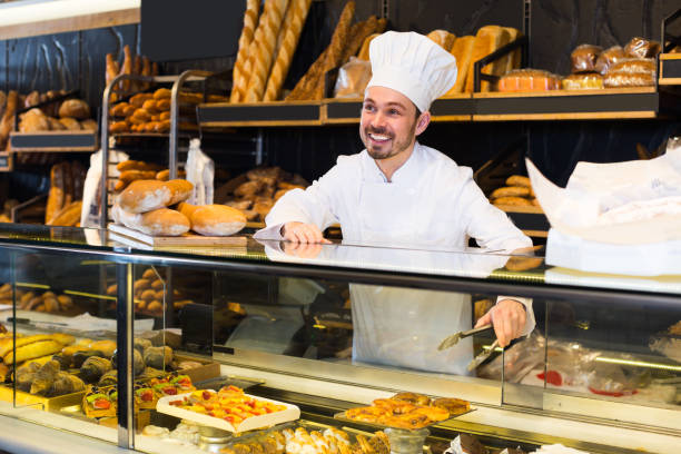 istock Male baker is demonstrating assortment 818554724