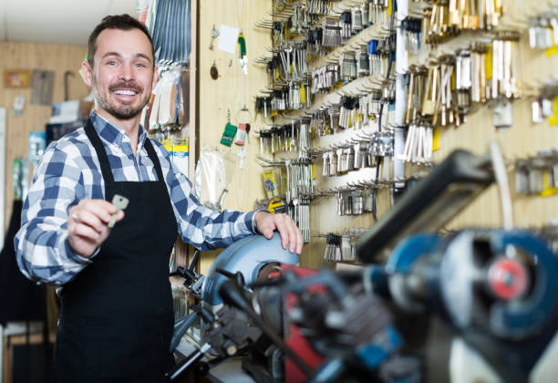 istock Worker displaying result of his key making in workplace 818557546