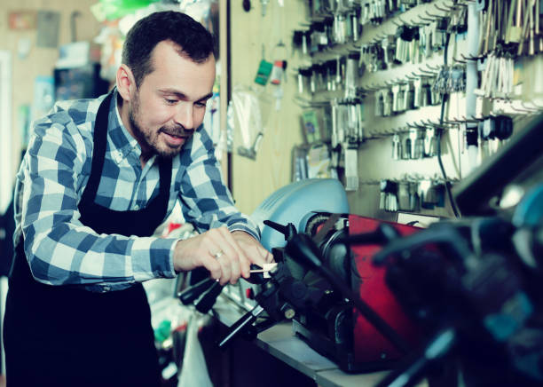 istock Smiling male worker shaping new key in workshop 818557576