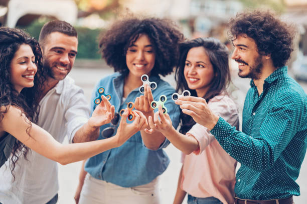 istock Group of people holding fidget spinners 818561100