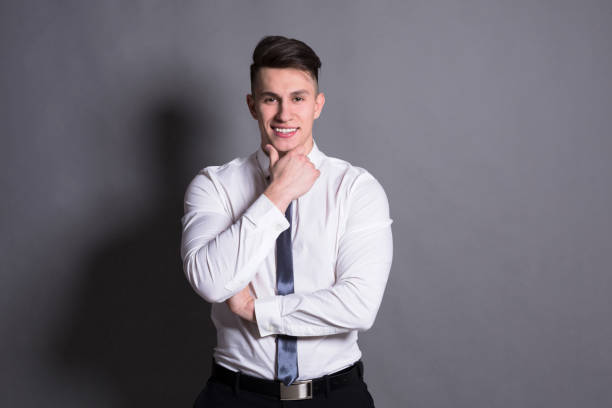 istock Confident businessman at gray studio background 818564132