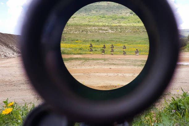 A look through an optical sight aimed at a group of potential targets at the range A look through an optical sight aimed at a group of potential targets at the range, outdoor shot, Israeli army IDF training zone telescope lens stock pictures, royalty-free photos & images