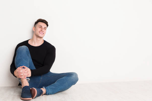 istock Smiling young man portrait at white studio background. 818566992