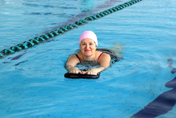 istock Middle Aged Woman in Swimming Pool 818567642
