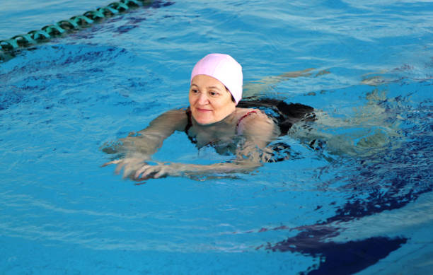 istock Middle Aged Woman in Swimming Pool 818569314