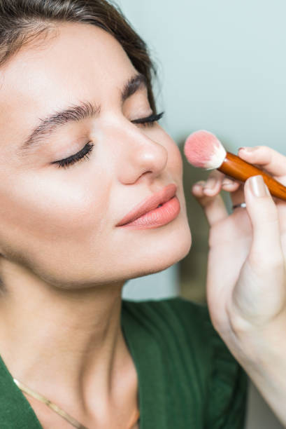 istock Woman applying cosmetic 818575758
