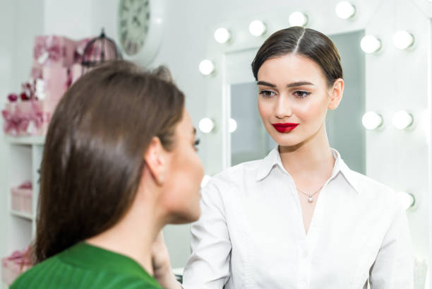 istock Woman applying cosmetic 818575946