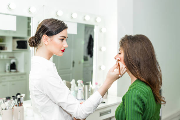 istock Woman applying cosmetic 818576320