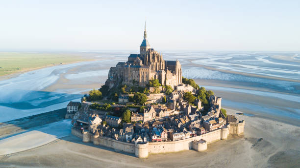 Le Mont Saint-Michel tidal island in beautiful twilight at dusk, Normandy, France Le Mont Saint-Michel tidal island in beautiful twilight at dusk, Normandy, France historic district photos stock pictures, royalty-free photos & images