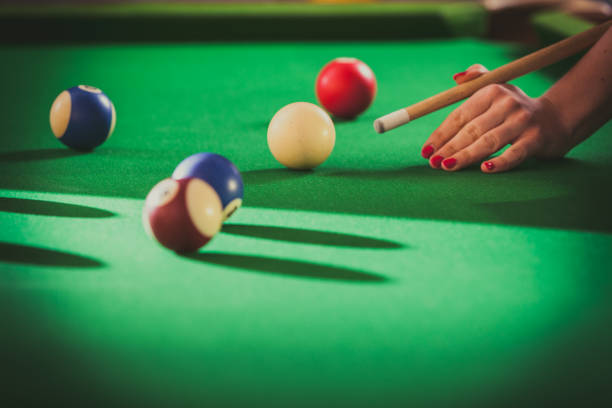 istock Young woman playing billiard. 818591730