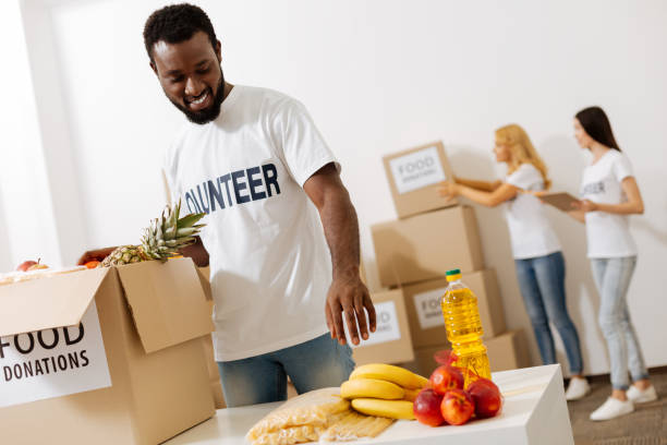istock Handsome enthusiastic man helping as a volunteer 818591782