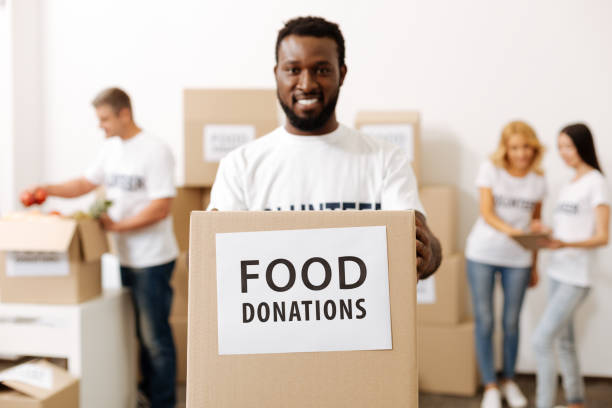istock Energetic strong guy carrying a box with donations 818593228