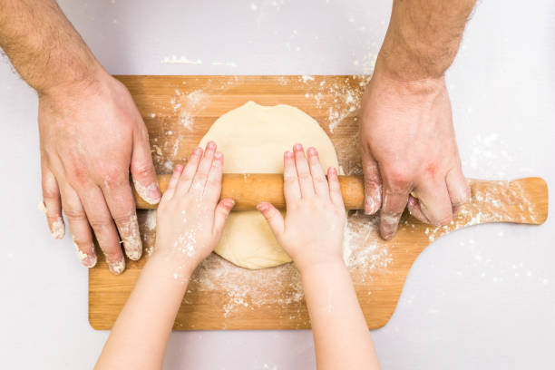 istock Children and dad hands rolled dough 818601902