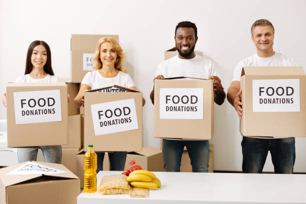 istock Active sincere people making their contribution to the noble cause 818607070