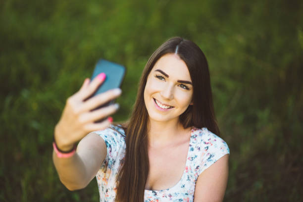 istock Girl taking selfie in the park 818623700