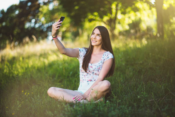 istock Girl taking selfie in the park 818623758