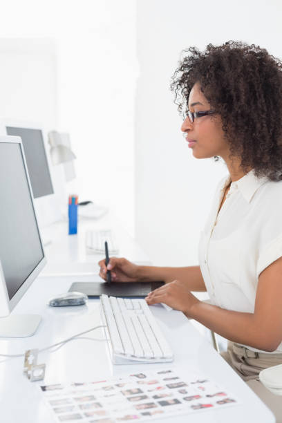 istock Pretty photo editor using digitizer at desk 818627090