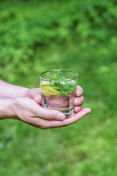istock Man holding a glass of water 818640922