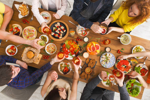 istock People eat healthy meals at served table dinner party 818642900