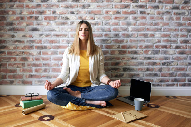 istock Young woman sits on the floor and meditates 818651564