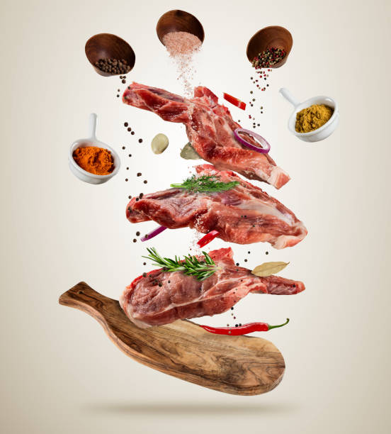 istock Flying raw pork steaks with ingredients, food preparation concept 818652768