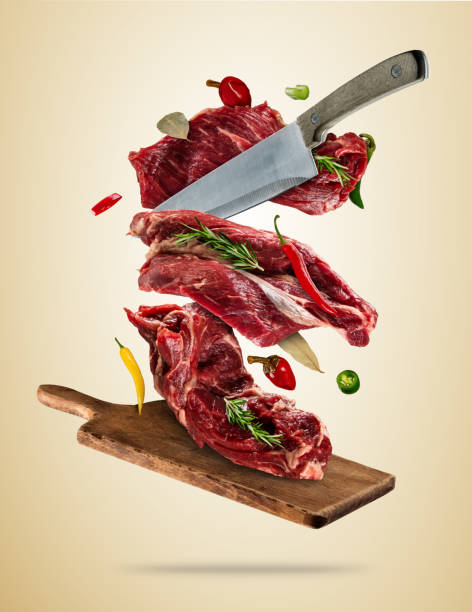 istock Flying raw steaks with ingredients, food preparation concept 818653904