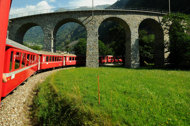 swiss red train bernina express pass on brusio viaduct, italy & switzerland - bernina express imagens e fotografias de stock