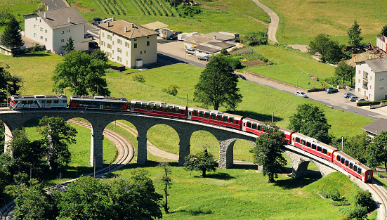 Swiss Red Train Bernina Express pass on Brusio Viaduct, Italy & Switzerland