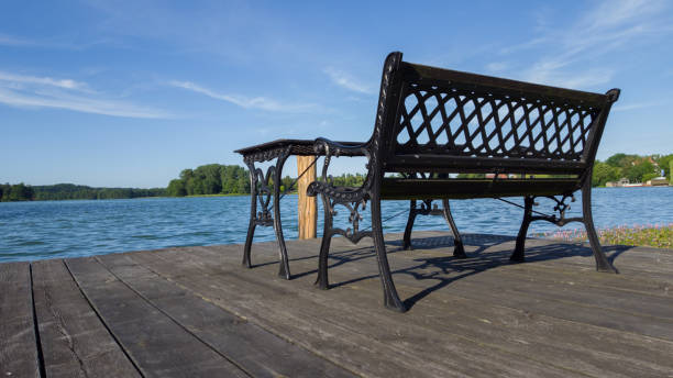 istock cast iron bench and table with view over blue lake 818704980