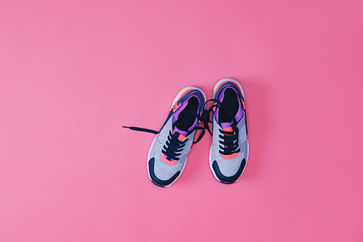 top view of pair of sneakers for fitness isolated on pink