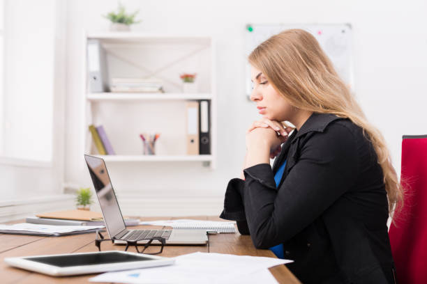 istock Pregnant woman working on laptop at office 818706848